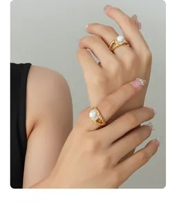 Close-up of 18K gold plated rope rings with freshwater pearls and zircon accents