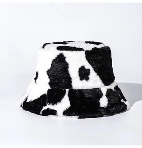 Close-up of the soft plush cow print texture on this warm winter bucket hat for women