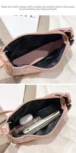 Detail showing the large capacity and internal storage of this pink quilted underarm bag