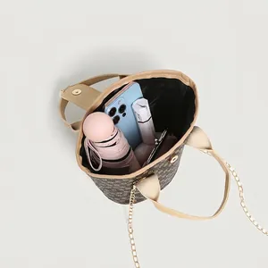 Vintage patterned bucket bag with chain strap, showing interior capacity with daily items