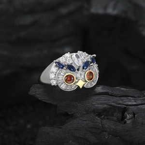 Exquisite s925 silver owl ring featuring orange and blue gemstones on a dark background