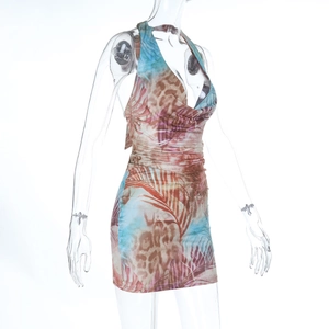 Detail view of tropical floral and leopard print halter neck mini dress fabric