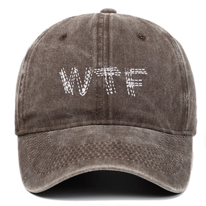 Macro detail of WTF embroidery on washed cotton vintage brown baseball cap