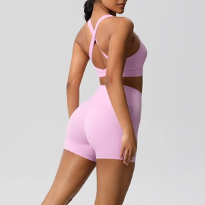 Pink high-stretch yoga set featuring a cross-back sports bra and high-waist fitness shorts