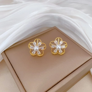 Titanium steel flower earrings with pearls and crystal pavé on a beige gift box