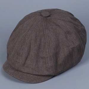 Detail of vintage coffee brown newsboy cap showing twill fabric texture and top button