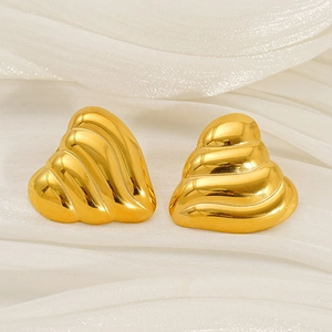 Detailed view of 18K gold plated stainless steel heart earrings with shell texture on silk