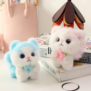 Cute plush angel cat keychain pendants in pink and blue fur with flower detail