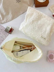 Lace floral embroidered cosmetic bags in cream and sage green with spacious interior