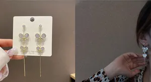 Detail view of 925 silver long gold tassel earrings with sparkling zircon butterfly accents