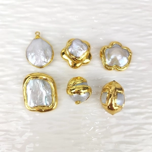Detail of baroque pearls with gold-plated edges in irregular shapes for DIY jewelry