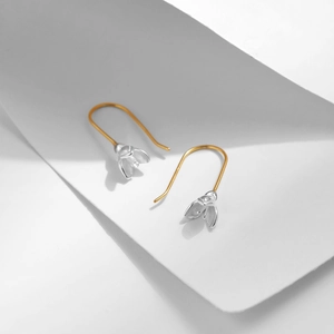 Elegant S925 sterling silver magnolia flower earrings with gold hooks on white background