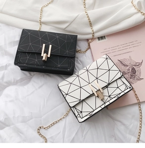Detail view of mini quilted crossbody bags in black and beige with gold chain straps