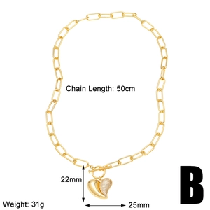 Detail view of gold paperclip chain necklace with zircon heart pendant and size specs