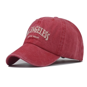 Close-up of vintage red washed cotton baseball cap with white Los Angeles embroidery