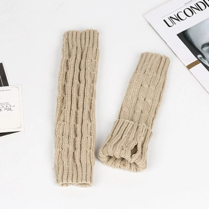 Detail of beige cable knit arm warmers with soft texture and ribbed cuffs for winter