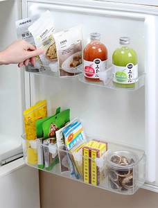 Detail of adjustable transparent fridge door dividers organizing bottles and food items
