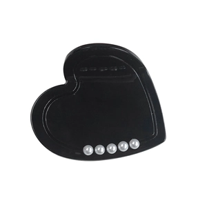 Elegant black heart acetate hair claw clip with inlaid pearls on a minimalist white background