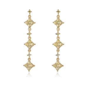 Detailed view of 18K gold plated tassel earrings with yellow zircon four-leaf clover motifs