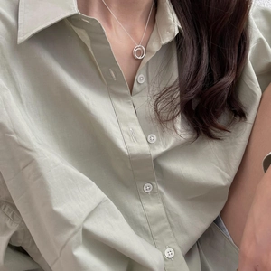 Close-up of minimalist 925 sterling silver necklace featuring double irregular oval pendants