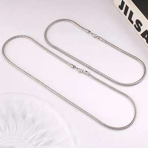 Close-up of polished silver foxtail chain necklace with secure lobster clasp detail