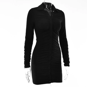 Detailed view of the black ruched texture and single-breasted buttons on the mini dress