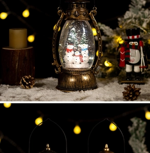 Detail of vintage gold Christmas lantern featuring snowmen and LED light snow globe