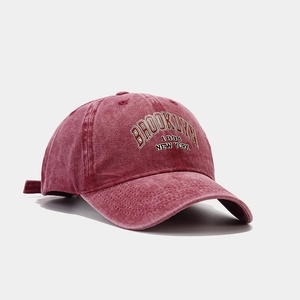 Detailed view of Brooklyn 1898 embroidery on a vintage washed burgundy baseball cap