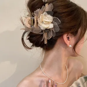 Detail of elegant mesh rose hair claw clip worn on a sophisticated updo hairstyle