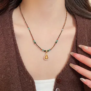 Ethnic gourd necklace with tiger eye beads and pavé zircons for an elegant vintage style