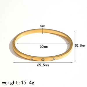 Detail view of gold stainless steel bangle with dimensions and weight measurements