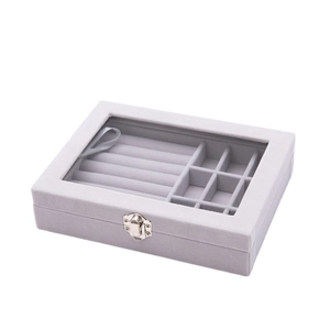 Gray velvet jewelry box with transparent glass lid and metal latch for rings and studs