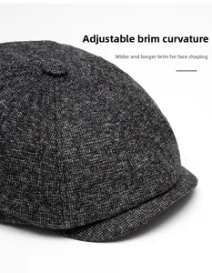 Detail of grey textured newsboy cap showing the foldable wide brim and warm wool material