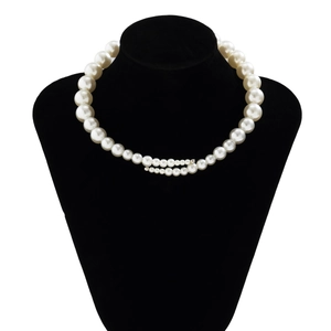 Detail of layered imitation pearl necklace with double strand drape on display stand