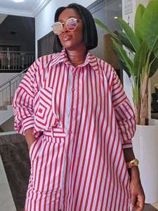 Detail of red and white vertical striped shirt featuring button-down front and collar