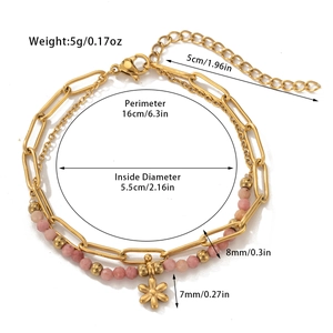 Detailed view of double-layer titanium steel bracelet with pink beads and gold flower charm