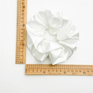 White glossy satin scrunchie shown with wooden rulers measuring 11-12cm diameter