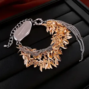 Multi-layer leaf tassel bracelet in mixed gold and silver tones for a stylish look