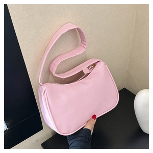 Pink PU leather crescent underarm bag with zipper closure shown by hand-held model