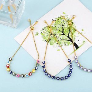 Detailed macro view of bohemian adjustable evil eye beaded bracelets with gold finish