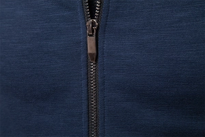 Macro shot of high-quality metal zipper and navy blue knitted fabric on men's jacket