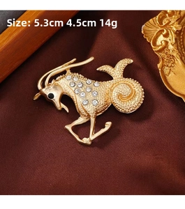 Detail shot of Capricorn goat brooch with white rhinestones and gold-plated finish