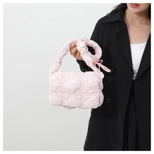 Close-up of quilted nylon cloud bag in light pink with ruched handle details