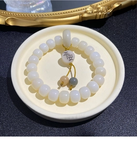 Detailed shot of white Bodhi beads bracelet with round Ping An safety jade pendant