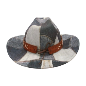 Close-up of patchwork denim cowboy hat showing blue fabric textures and leather band