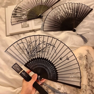 Three Chinese folding bamboo fans with ink painting floral patterns and elegant tassels