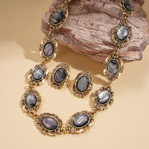 Vintage gold oval resin necklace and earrings set with iridescent gemstone inlay on stone