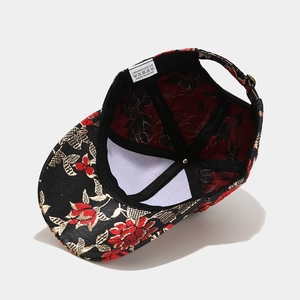 Retro baseball cap featuring red and gold floral embroidery on black polyester fabric
