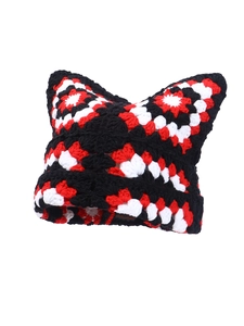 Detail of crochet cat ear beanie featuring red, white and black grandmother square pattern