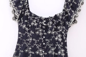 Detailed view of floral embroidery on black retro midi dress with ruffle sleeve